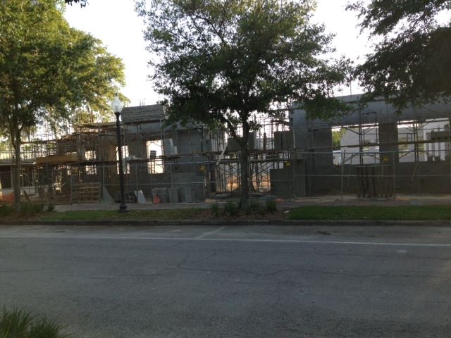 front of grey building 