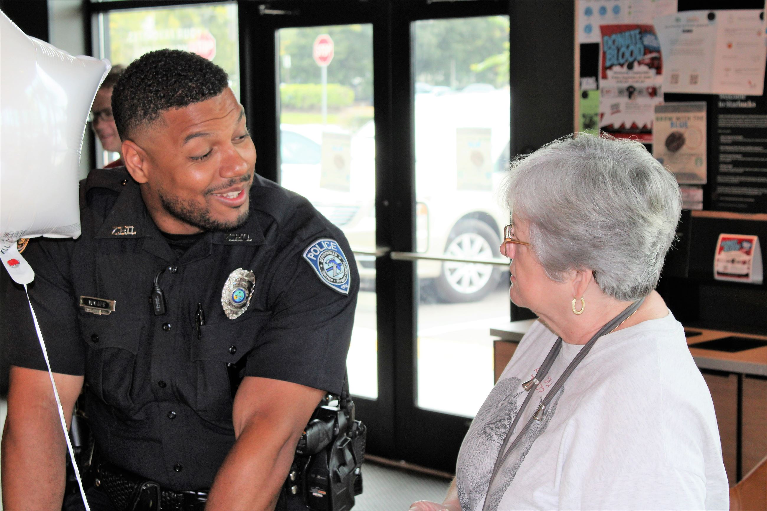 Zephyrhills Police Patrol Officer Walker meets with a resident
