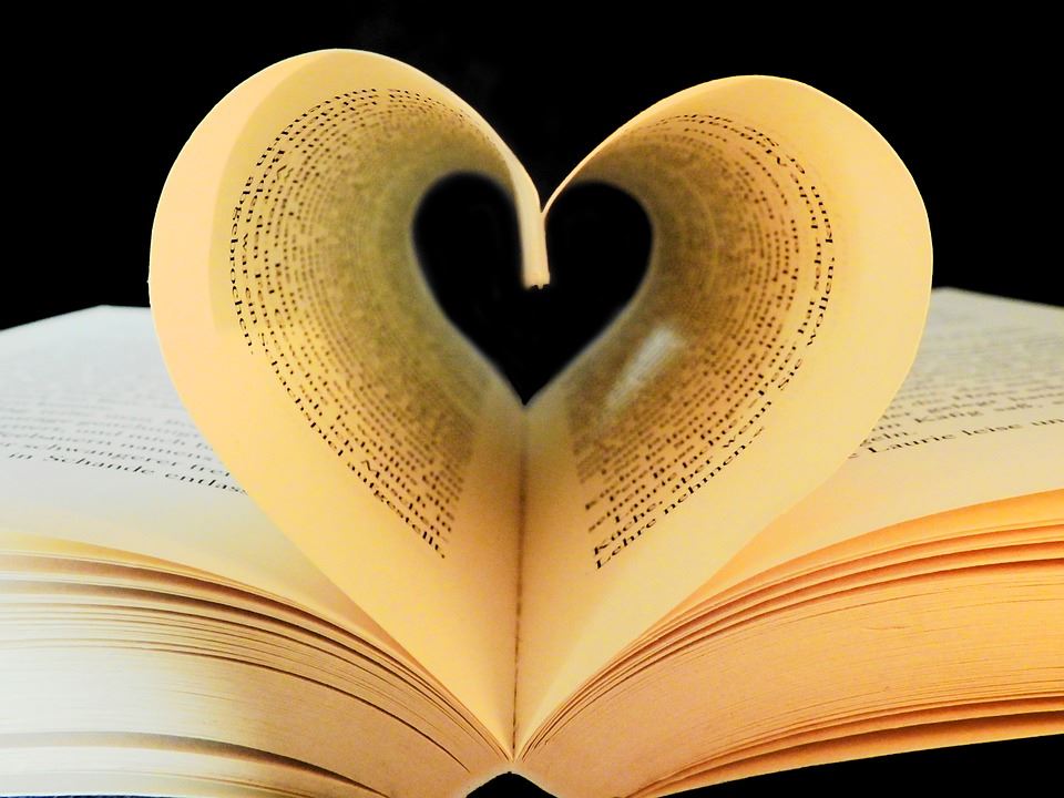 Open book with pages forming heart